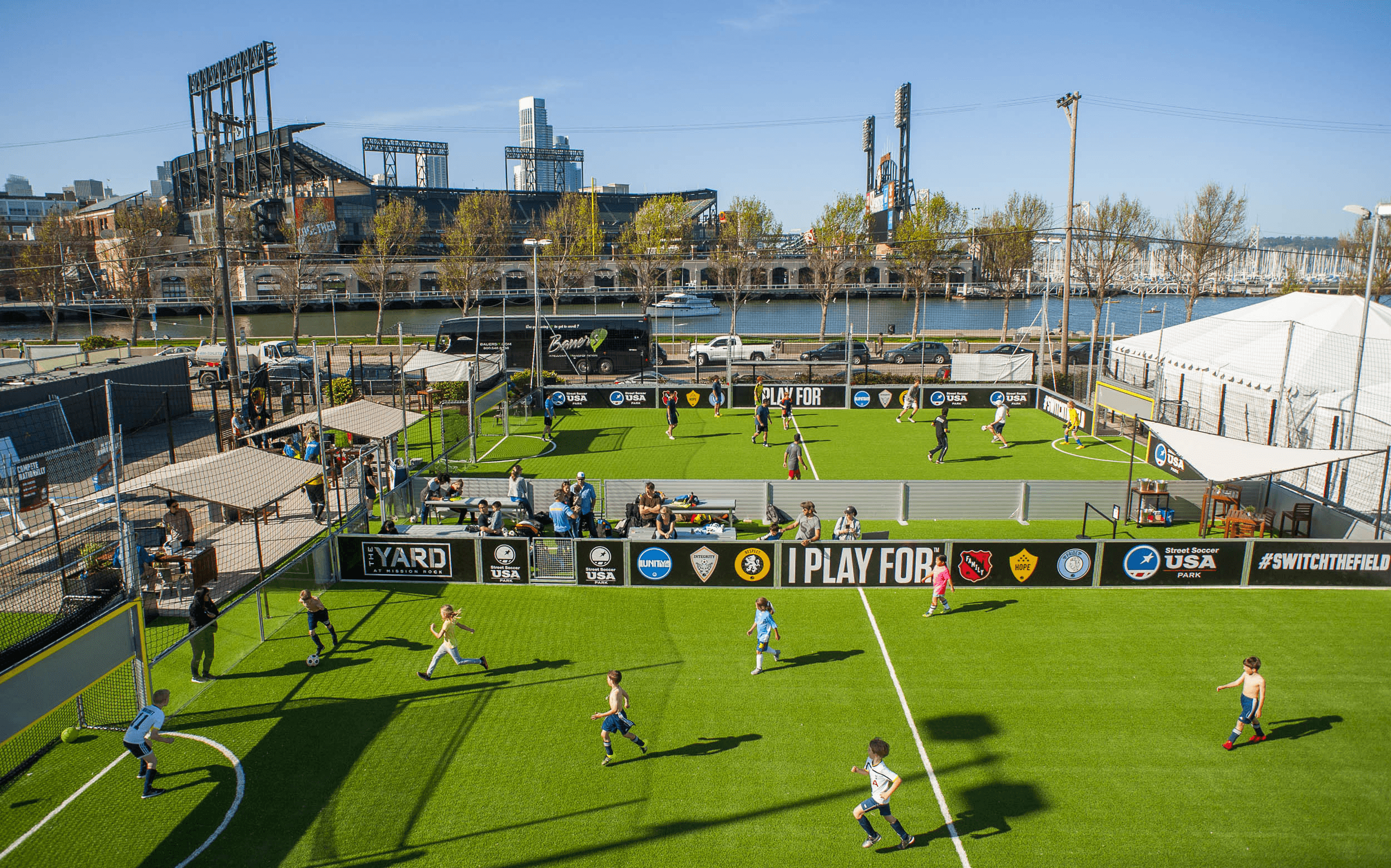Kids playing soccer on an outdoor 5-a-side field